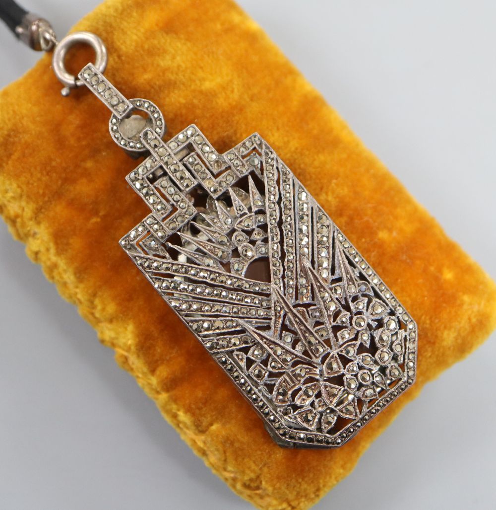 A 1930s Art Deco French white metal and marcasite set lorgnettes pendant, on a fabric necklace, lorgnettes 58mm.